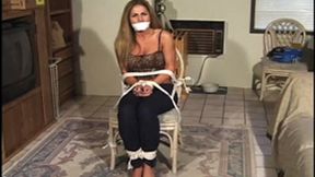 Pretty Sofia Samuels sits roped to a chair, her hands tied in front, bare feet toe-tied and a cloth tightened over her mouth!