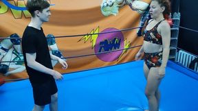 Fit redhaired girl dominates a young guy in the ring