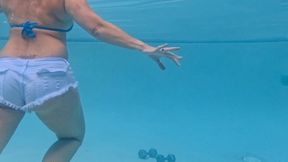 Carissa working out with weights in the pool wearing booty shorts