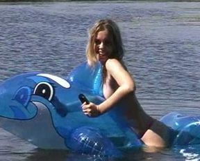 Attractive brunette chick with well shaped body swims i the lake