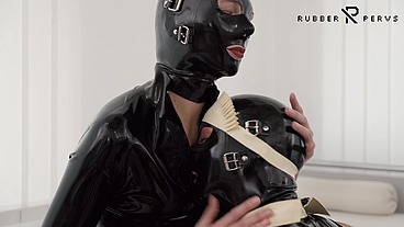 The Rubberdoll Maid serves his smoking Mistress