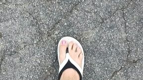 in blocked flip flops in laundry parking lot
