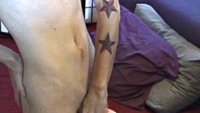 Dan's clothes quickly strip off and he pumps steadily with his left hand, showing the two stars tattooed on his forearm. Lubrication enhances Dan's serious stroke show.