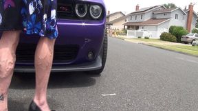 Goth Tempest flexes by muscle car
