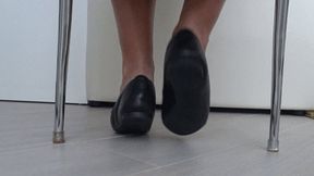 Play of shoes and bare feet under the chair aa
