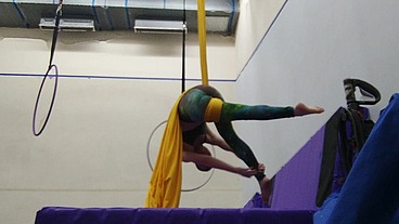 Practicing hip locks on the aerial silks