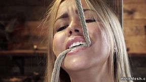 Blonde dominated upside down in rough bondage