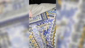 Mom in short dress, son barechested, intimate moment in bed