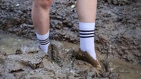 Muddy nylon socks, white socks in a deep mud, wet and muddy white socks, white socks stuck