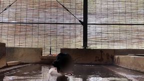 japanese girl bathing in a mixed outdoor bath at a hot spring inn