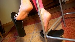 Amateur Milf Dangles Her Black Flip-flops While Sitting In The Chair