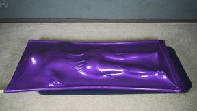 Butt flogging on a mattress in a purple vacuum bed