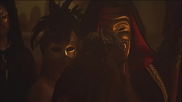 This masked brunette is chained to the bed and awaiting orders