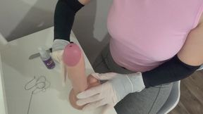 circumcising a giant dildo in white medical gloves