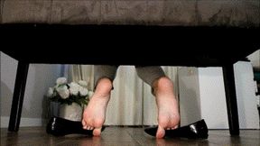 Shoe play , ballet flats gripped by the toes , wrinkled soles