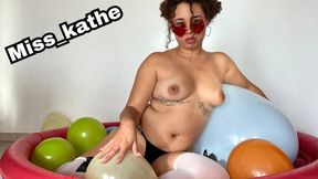 An inflatable pool with many small balloons plus a special balloon