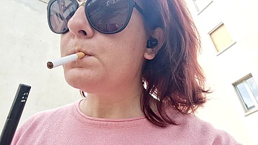 Sexy Italian in the public garden smokes and shows you her big breasts