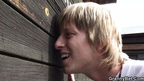 Blonde granny seduces him in the public cubicle
