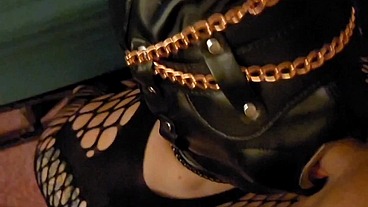 Belle is locked in her mask and handcuffed to the bed so her master can use her mouth and cum down her throat.