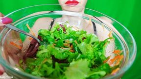 chewing and eating colorful salad