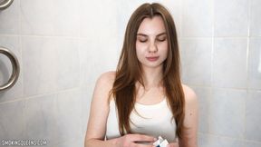 Stella is smoking Eve 120s cigarettes in the bathroom at home using matches