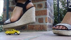 Christine crushes a yellow toy car and plays with her shoes