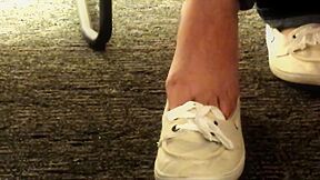 Keds Dangling Under School Room Desk