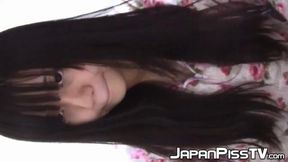 Japanese seductress toys with her feline while drinking from cups