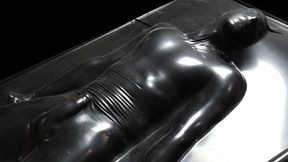 Black latex vacbed bondage