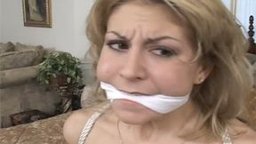 Pretty Brianna is Tied to a Bed Post, A Cleave Gag in Her Mouth and Nice, Perky Tits Exposed!