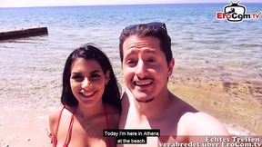 German traveler toys with two Latinas on the beach