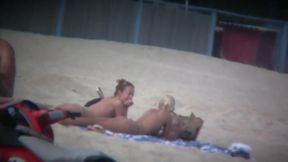 Beach spy captures two friends sunbathing topless