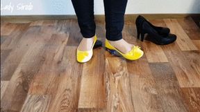 Crushing a toy car and a pc mouse with yellow ballerinas and black Pumps