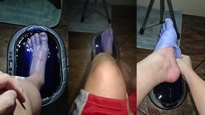pov dipping foot in paraffin view
