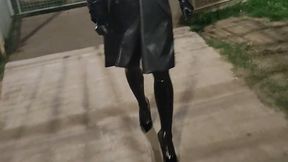 Tania walks in the street in latex