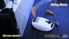 Kitty Blair vacuuming arround sofa close view cam