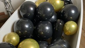 Latex balloon bath Rubber Missy dressed in latex catsuit is bathing in black and gold latex balloons mask fetish and rubber fetish