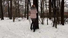a girl walks through the winter forest in extremely high heels ballet boots