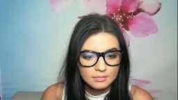 Sexy Dark Haired Girl Wearing Glasses Looks at You Through Her Web Cam