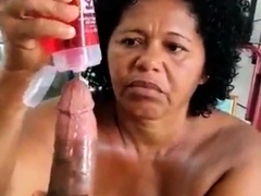Voluptuous ebony granny jerks off a big black cock in POV