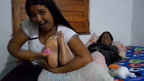 Lalita tickles Rebeca's feet