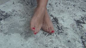 Bare feet rub against each other Fd