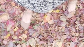 Tempest walking in leaves with her tan flats