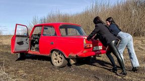 CAR STUCK Two girls in a car stuck in the mud