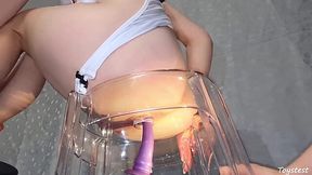 My boyfriend fucked my ass with a sex toy while I was sitting on a transparent chair.