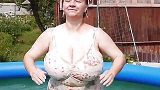 MILF wrinkles boobs with her hands, checking elasticity and at the same time trying to satisfy herself