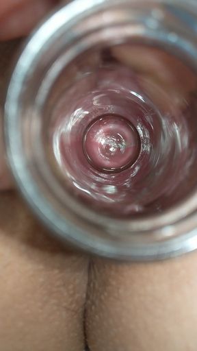 cervix watching through glass tube inserted into creamy pussy