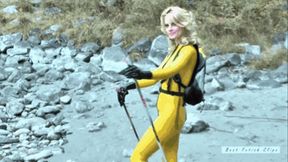 Blonde girl in yellow latex catsuit hiking