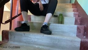 Dirty Vans shoe soles licking in tha public stairs