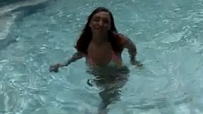 A horny brunette by the pool is sucking off his small cock